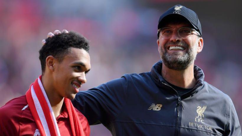 Jurgen Klopp, manager of Liverpool embraces Trent Alexander-Arnold of Liverpool