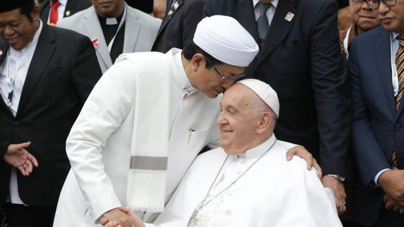 Grand Imam of Istiqlal Mosque Nasaruddin Umar (L) shakes hands with Pope Francis 