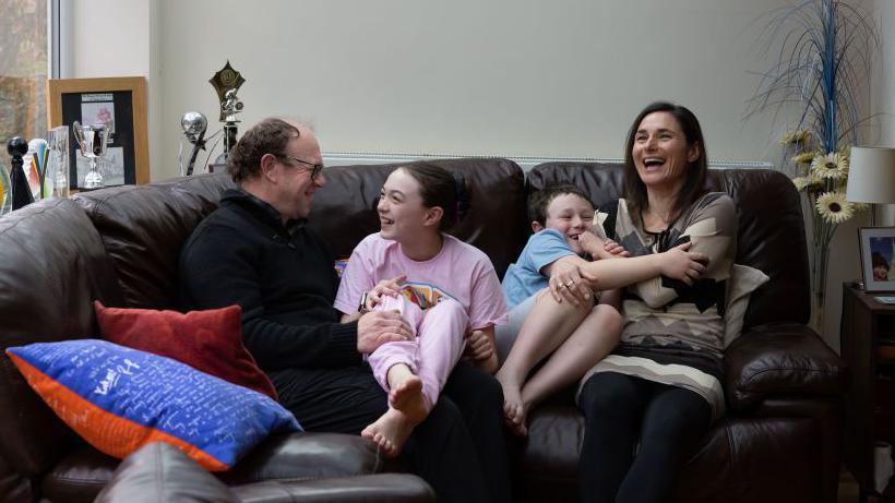 Dame Sarah Storey at home with husband Barney Storey, daughter Louisa Storey and son Charlie Storey