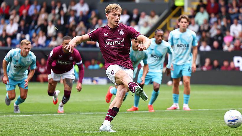 Zian Flemming slots the ball home right-footed from the penalty spot to score the first of his two goals in Burnley's 2-2 draw with West Ham at Turf Moor.