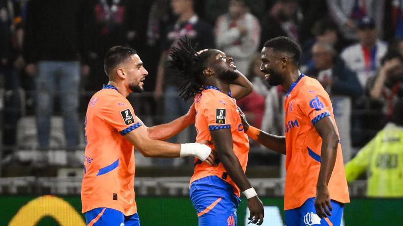 Marseille's Jonathan Rowe celebrates his 90th-minute winner against Lyon 