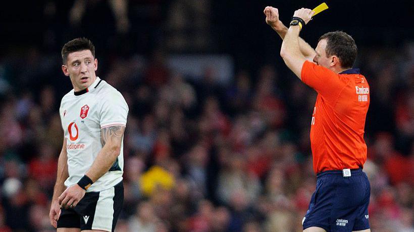 Josh Adams is shown a yellow card by English referee Matthew Carley
