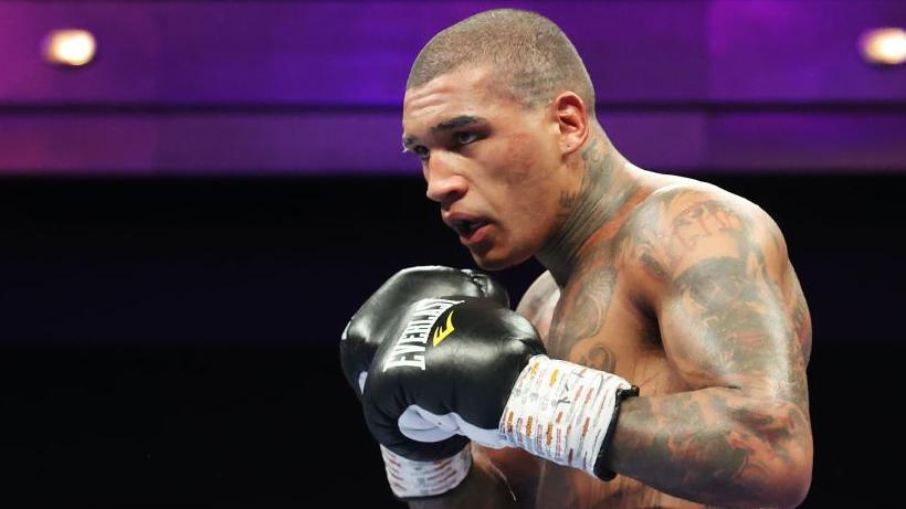 Conor Benn in black gloves during a fight