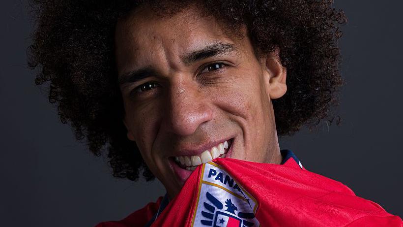 Adalberto Carrasquilla has the Panama shirt and crest in his mouth as he poses for a portrait prior to the World Cup