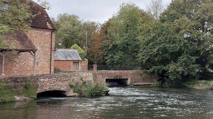 The River Test at Sadler's Mill, a brick building and bridge in Romsey