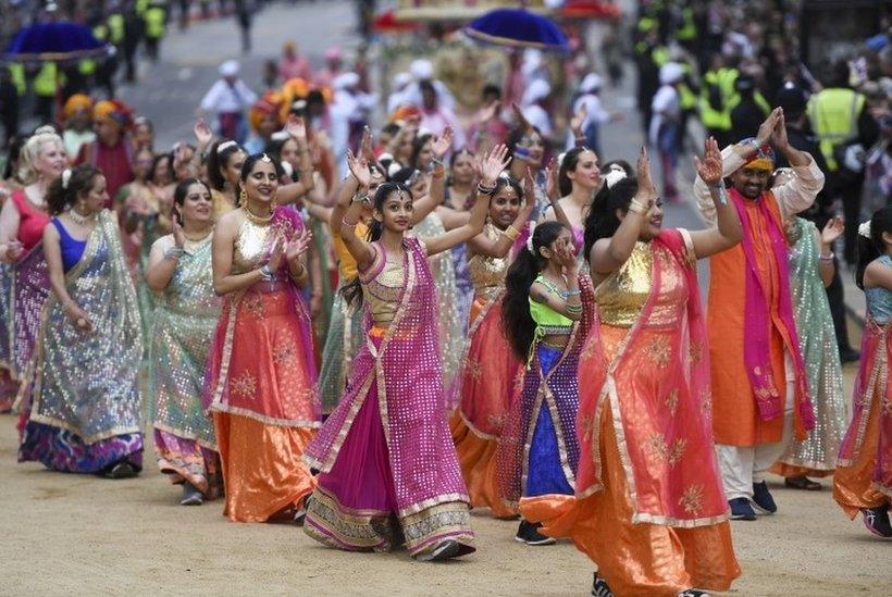 Participants perform a Bollywood wedding scene as they parade during the Platinum Pageant celebrating Queen Elizabeth II Platinum Jubilee in London.