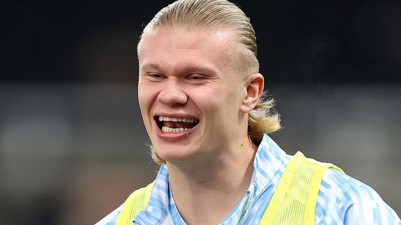 Manchester City striker Erling Haaland smiling before a game
