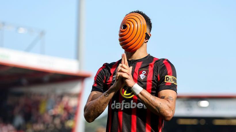 Dominic Solanke celebrates wearing an orange mask