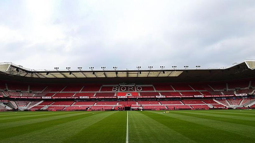 A view of the main stand at Middlesbrough's Riverside Stadium with "Boro" in white letters across the seats in the upper tier 