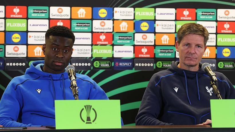 Marc Guehi and Oliver Glasner manager sat side by side during a media conference ahead of the Conference League match between Dynamo Kyiv and Crystal Palace in October.