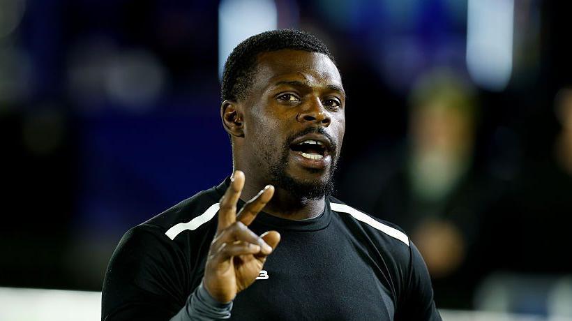 Christian Wade with his right hand up and three fingers raised in Newcastle Red Bulls training gear