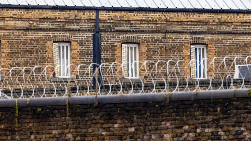 Barbed wire on an external wall at a prison