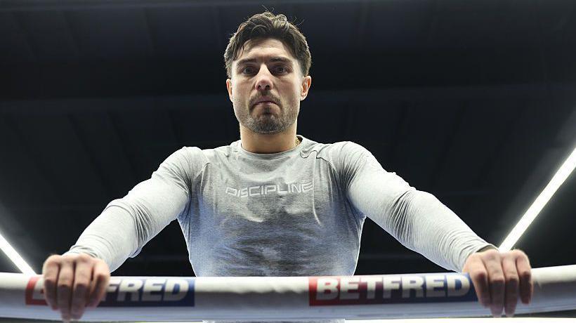 Josh Kelly leans over the ropes