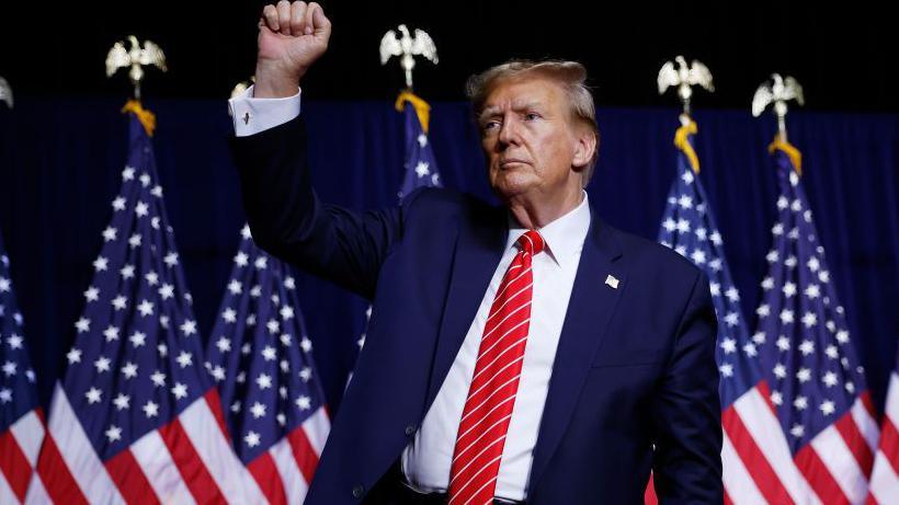  Republican presidential candidate and former U.S. President Donald Trump stands on stage a the conclusion of a campaign rally