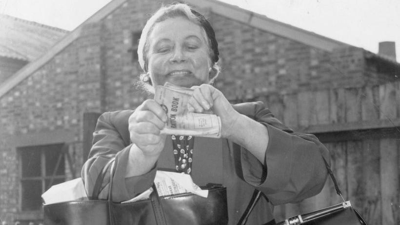 Mrs Ann Smith of Wandsworth in south London tears up her ration book on the last day of rationing in 1954, which went on for 14 years during wartime. 