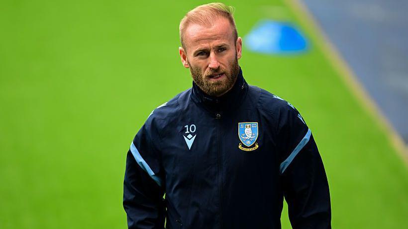 Barry Bannan, dressed in a navy blue Sheffield Wednesday tracksuit top