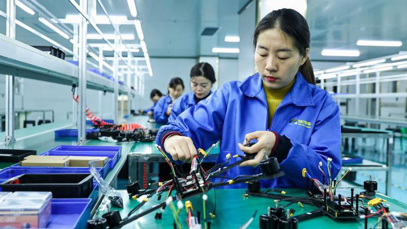 Female employees work on a production line of drones in a Chinese factory