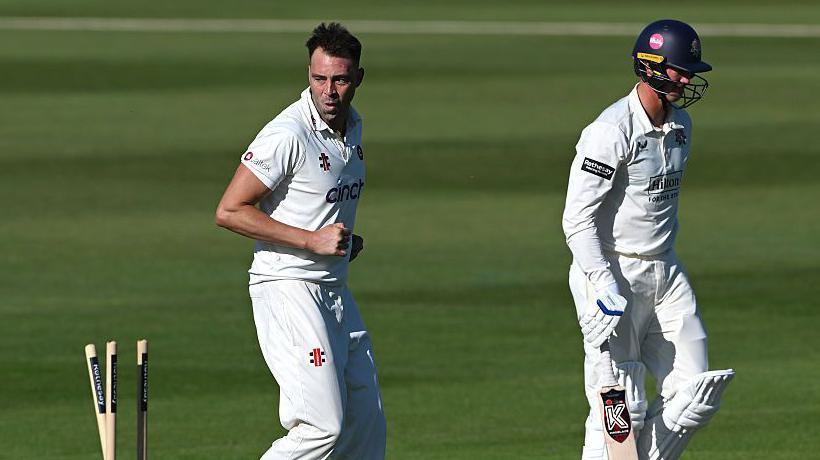 Lancashire batsman Keaton Jennings (right) walks off after being bowled by Northamptonshire's Harry Conway (left)