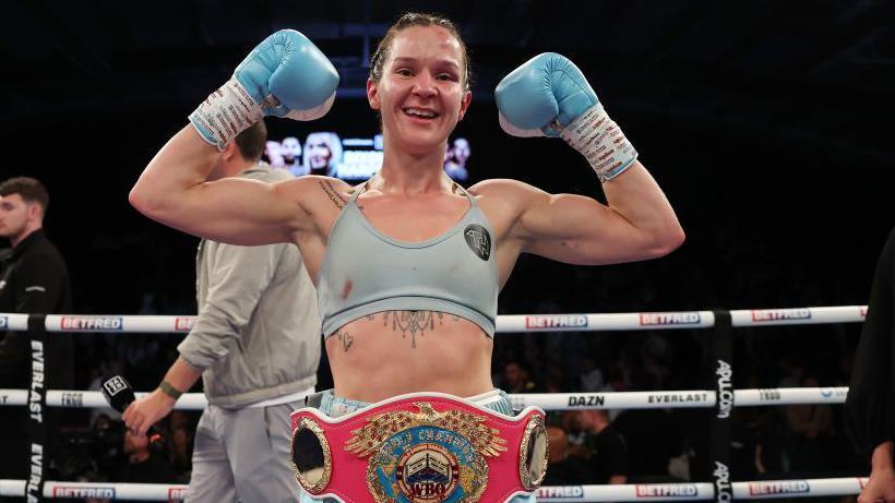 Terri Harper celebrates with her WBO belt around her waist