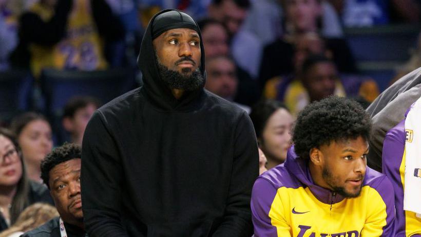 LeBron James and son Bronny on the LA Lakers bench during Sunday's game against the Portland Trail Blazers