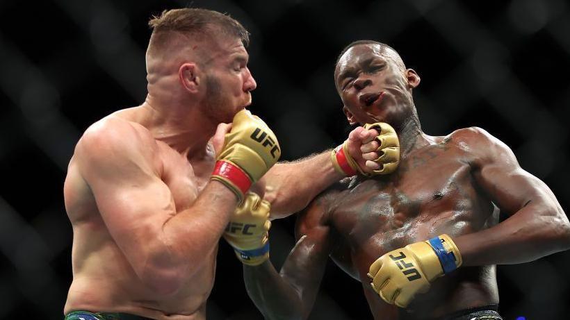 Dricus du Plessis lands a punch on Israel Adesanya