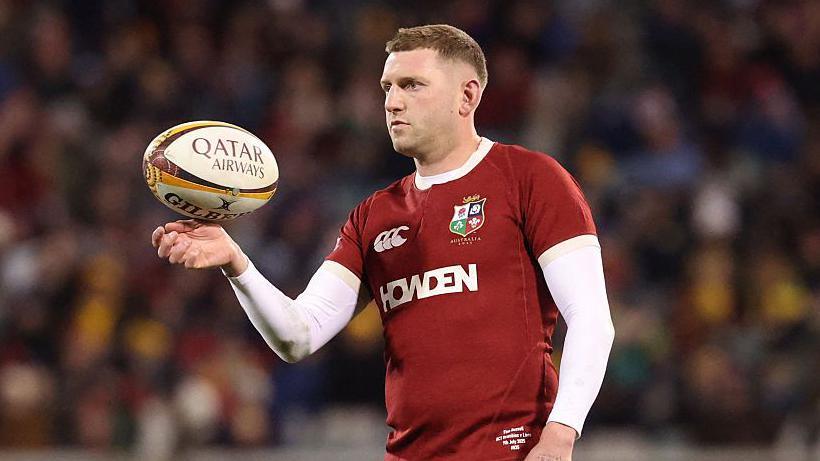 Finn Russell spins a rugby ball