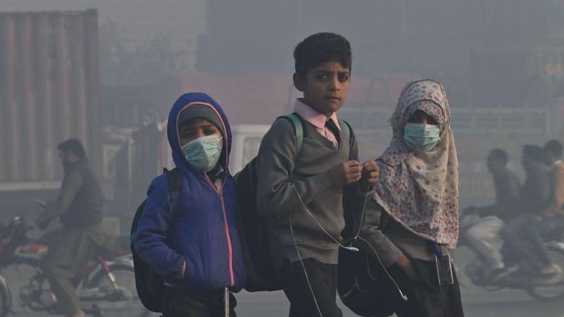 Children engulfed in smog on the streets of Lahore