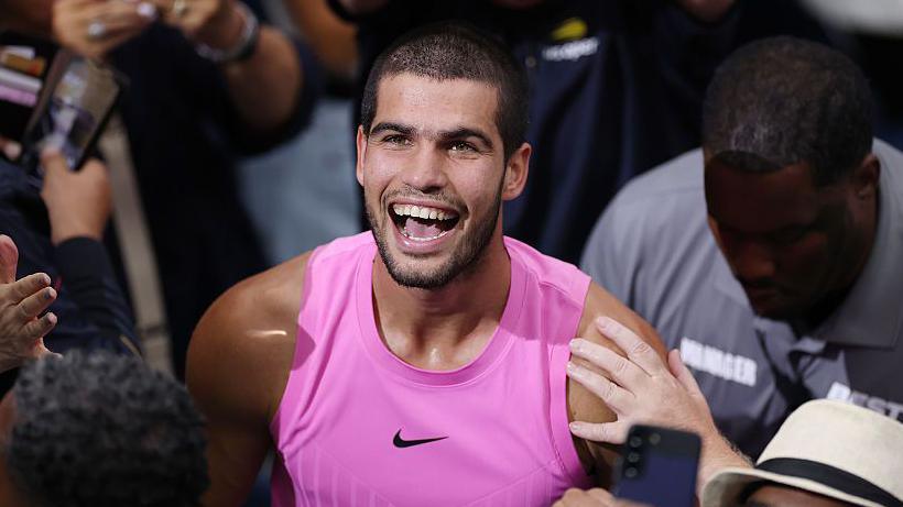 Carlos Alcaraz smiles after winning the US Open