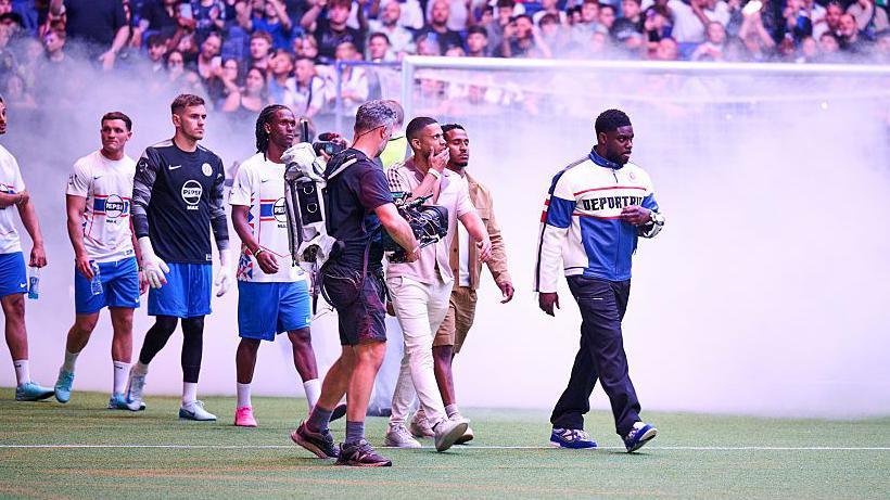 Micah Richards (furthest right) walks onto the pitch at Baller League UK
