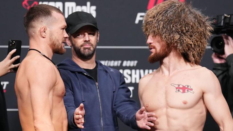 Merab Dvalishvili (right) faces off with Petr Yan