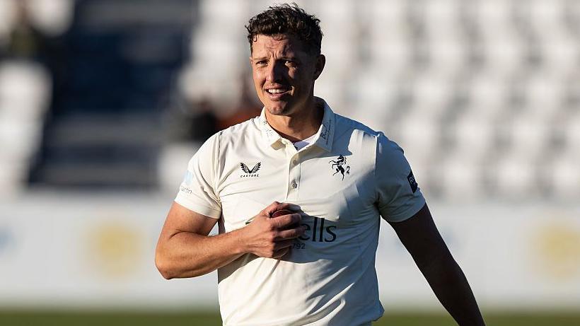 Keith Dudgeon looking on while playing for Kent against Northamptonshire, dressed in a white kit