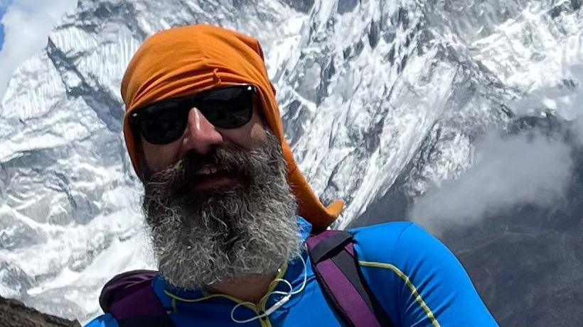 Trevor Rigley in sunglasses with Mt. Everest in the background