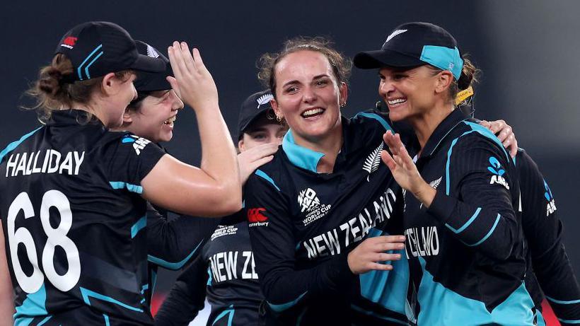 Amelia Kerr (centre) celebrating a wicket with her teammates