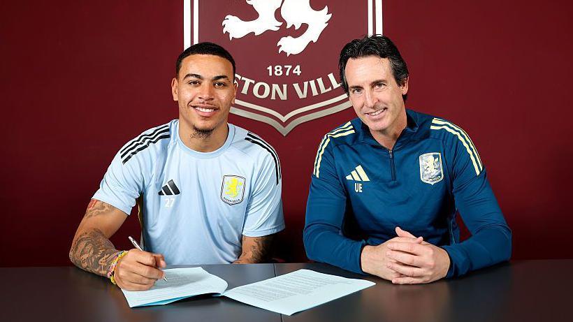 Morgan Rogers signing a contract alongside Unai Emery at training ground