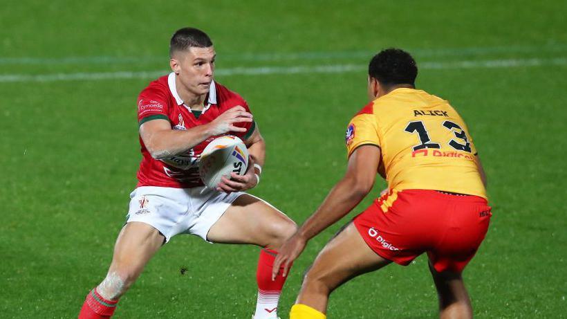 Josh Ralph of Wales looks to break past Jacob Alick of Papua New Guinea during the Rugby League World Cup 2021 Pool D 