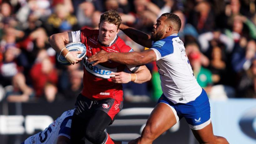 Gloucester's Ollie Thorley runs with the ball while being tackled by Ollie Lawrence