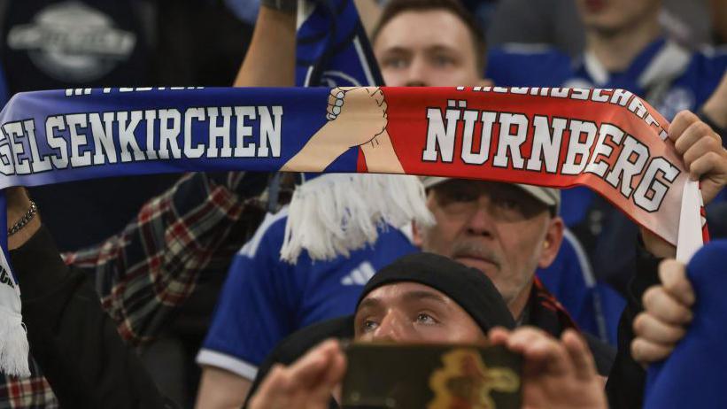 Schalke and Nuremberg fans with a half-and-half scarf