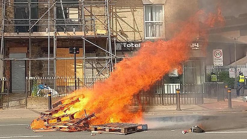 Pallets of wood burning on fire