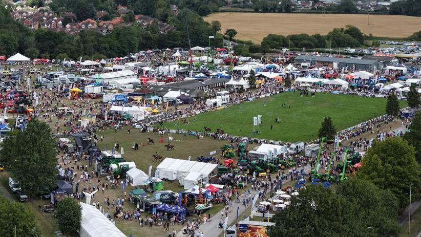 Aerial view of the Driffield Showground showing a large grass paddock and a number of marquees and people walking around stalls
