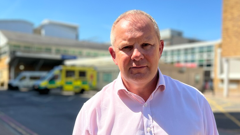 Steve McManus stood outside the Royal Berkshire Hospital in Reading, wearing a light pink shirt.