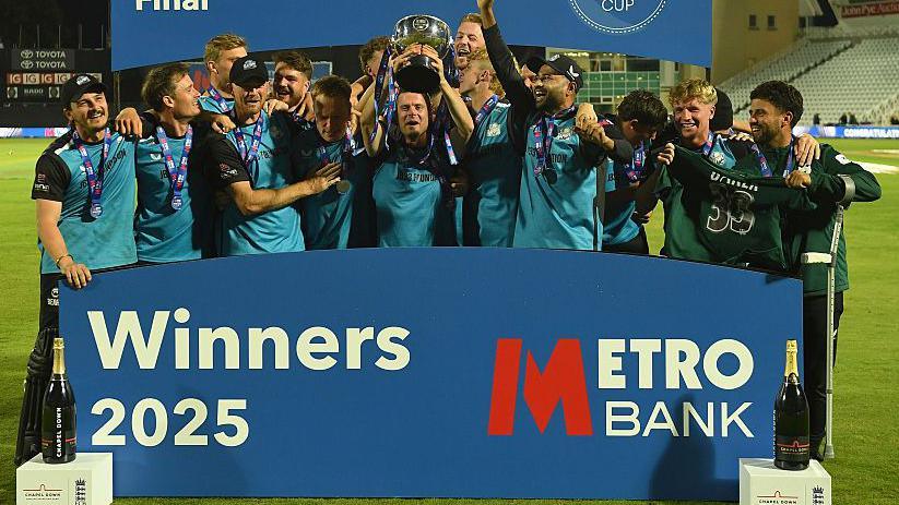 Jake Libby lifts the One-Day Cup surrounded by his celebrating Worcestershire teammates