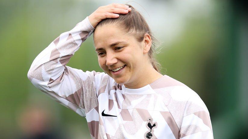 Kit Graham, with right hand on her head, during a Tottenham training session
