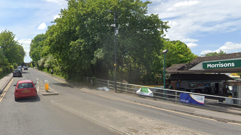 Cars driving down a road near Morrisons