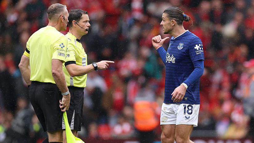 Jack Grealish speaks to referee Darren England