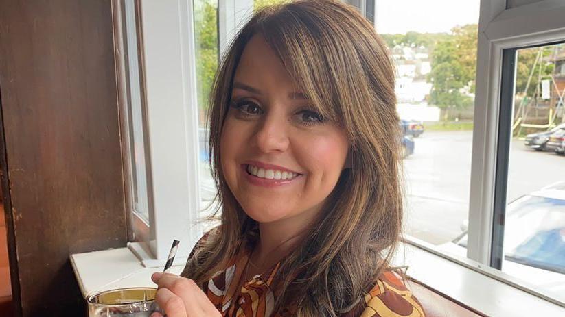 Former Miss Wales Sara Manchipp stands in front of a window