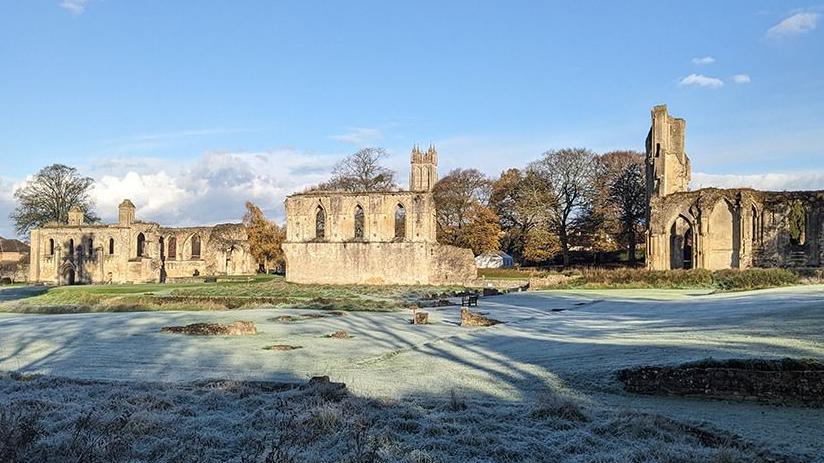 Glastonbury Abbey with the ruins seen on a frosty day with the sky blue and clear