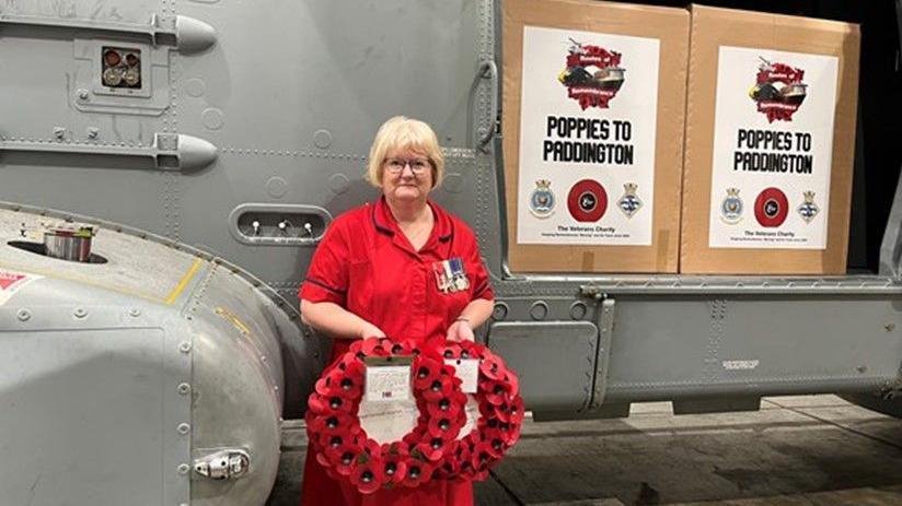 Sue Greenwood holding a poppy wreath