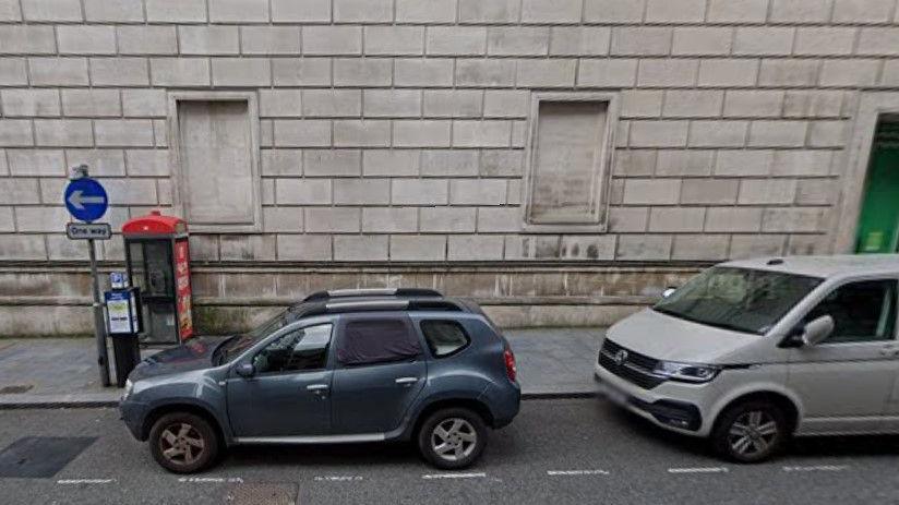 Two cars parked on a meter bay in North John Street, Liverpool