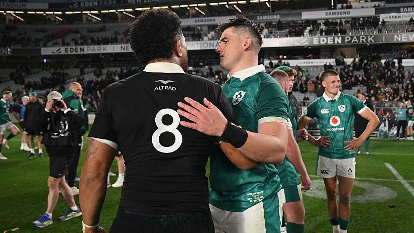 Dan Sheehan speaks to Ardie Savea after Ireland's defeat by New Zealand