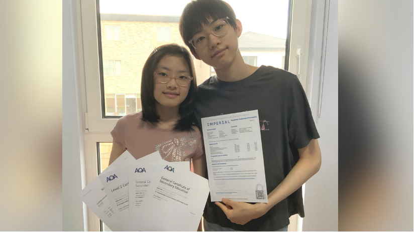 Ariel posing for a picture with her brother Elias. They are holding her GCSE results and his unconditional offer from Imperial College London. Both of them are wearing glasses.